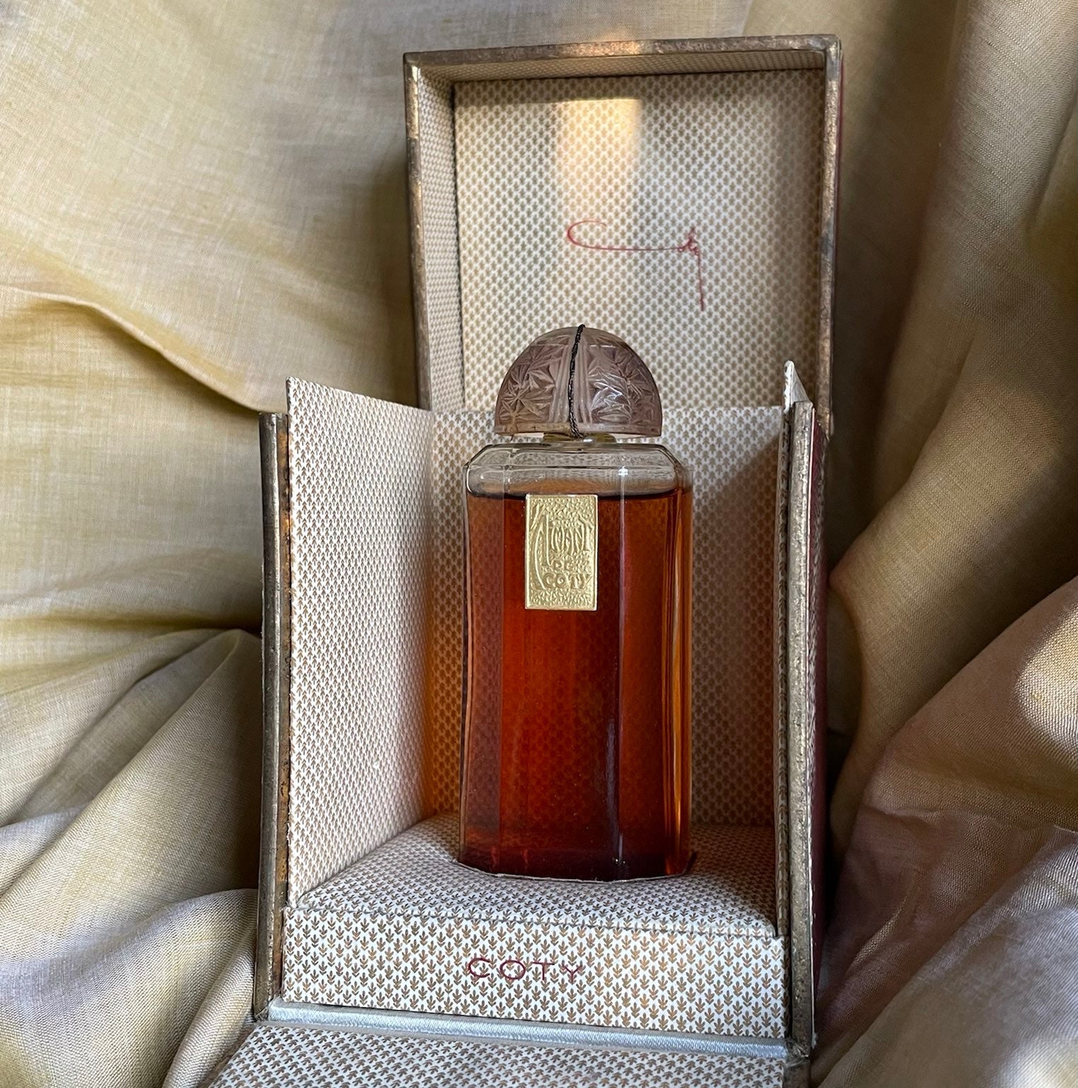 Editorial hero image of a perfume bottle for authentic Arabic perfume article